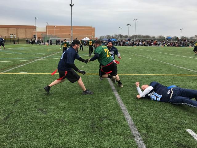 A NP alum attempts to grab an LC alums flag during the second annual Thanksgiving Day Alumni Game in 2016