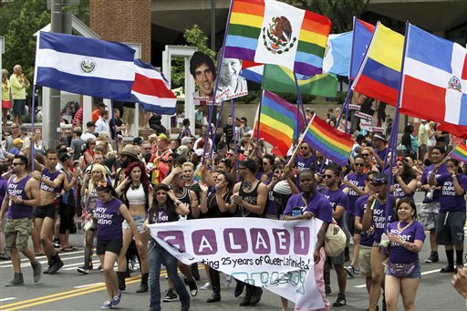 FILE - In this Sunday, June 8, 2014 file photo, people march in the annual Pride Day Parade in Philadelphia. Around the globe, LGBT Pride Month has been marked with parades and marches, festivals and dances, and in some cases, protests and counter-protests. In the United States, much of the celebrations have focused on a string of victories in states where gay marriage bans were overturned. Same-sex marriage is now legal in Pennsylvania. (AP Photo/ Joseph Kaczmarek, File)