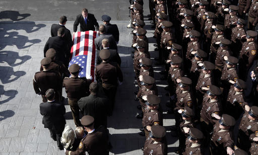 Members of the law enforcement community salute as St. Louis County police officer Blake Snyders casket is carried out of his funeral service Thursday, Oct. 13, 2016, in Chesterfield, Mo. Hundreds of police officers from around the country turned out to pay their respects for Snyder, who was fatally shot while on duty Oct. 6 after encountering a man accused of causing a disturbance in a normally quiet, middle-class suburban St. Louis neighborhood. (AP Photo/Jeff Roberson)