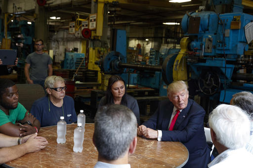 Republican presidential candidate Donald Trump talks with a group of factory workers during a tour of McLanahan Corporation headquarters, a company that manufactures mineral and agricultural equipment, Friday, Aug. 12, 2016, in Hollidaysburg, Pa. (AP Photo/Evan Vucci)