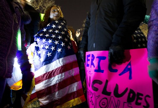 Demonstrators holds banners as they protest during a march in downtown Washington in opposition of President-elect, Donald Trump, Saturday, Nov. 12, 2016. Tens of thousands of people marched in streets across the United States on Saturday, staging the fourth day of protests of Donald Trumps surprise victory as president. (AP Photo/Jose Luis Magana)