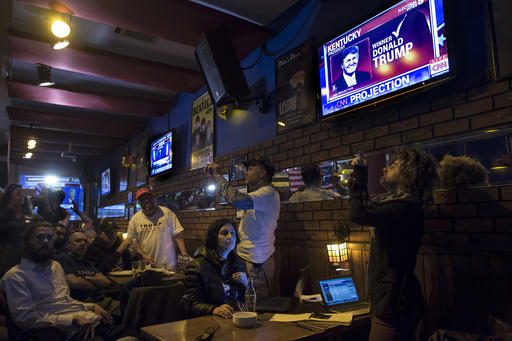 Israelis and Americans watch a live update of the US presidential election results at Mikes place bar in Jerusalem, Wednesday Nov. 9, 2016. (AP Photo/Tsafrir Abayov)
