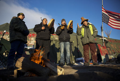 Native Americans from left, Eugene Sanchez, Jason Umtuch, Martan Mendenhall, and Hugh Ahnatook, all of Portland, Ore., drum and sing at the Oceti Sakowin camp where people have gathered to protest the Dakota Access oil pipeline in Cannon Ball, N.D., Sunday, Dec. 4, 2016. The U.S. Army Corps of Engineers said Sunday that it wont grant an easement for the Dakota Access oil pipeline in southern North Dakota, handing a victory to the Standing Rock Sioux tribe and its supporters, who argued the project would threaten the tribes water source and cultural sites. (AP Photo/David Goldman)