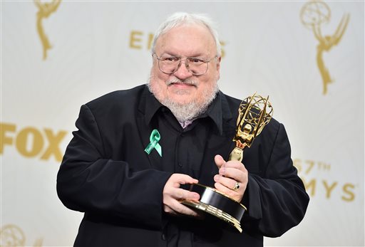 FILE - In this Sept. 20, 2015, file photo, author George R. R. Martin, winner of the award for outstanding drama series for Game of Thrones, poses in the press room at the 67th Primetime Emmy Awards at the Microsoft Theater in Los Angeles. In a Jan 2, 2016 blog entry, Martin acknowledges he missed the Dec. 31 deadline for the latest book in his fantasy series, titled The Winds of Winter, and the finished novel is still months away. Game of Thrones, the HBO television season based on the novel will start airing in April 2016, while hes still writing. And that means a big-time spoiler alert for millions of fans. (Photo by Jordan Strauss/Invision/AP, File)