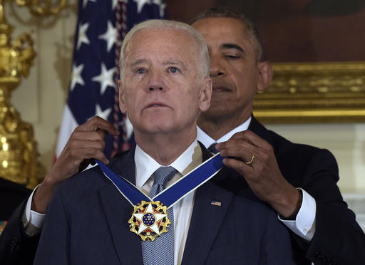 President Barack Obama presents Vice President Joe Biden with the Presidential Medal of Freedom during a ceremony in the State Dining Room of the White House in Washington, Thursday, Jan. 12, 2017. (AP Photo/Susan Walsh)