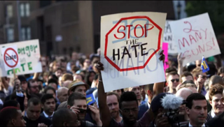 Members of the LGBT community and their supporters gather to speak out after a string of bias attacks, including the fatal shooting of 32-year-old Mark Carson on Saturday, during a rally in New York’s Greenwich Village, Monday, May 20, 2013. (AP Photo/Jason DeCrow)