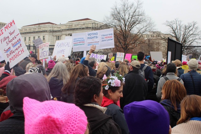 Women, men, and children gather in Washington, D.C. for the Womens March on January 21st, the day after President Trumps Inauguration.