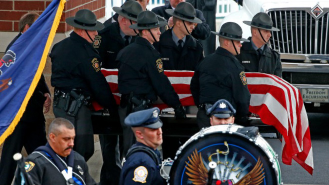 Pennsylvania State Trooper Landon E. Weavers casket is carried to a hearse following a memorial service at the Blair County Convention Center in Altoona, Pa., Thursday, Jan. 5, 2017. Trooper Weaver  was killed answering a domestic disturbance call on Dec. 30. Weaver, 23, had been on the force for less than six months. (AP Photo/Gene Puskar)