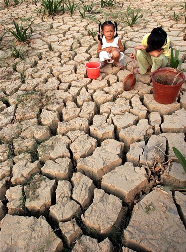 Chinese girls play on a parched land in Nanning, southern Chinas Guangxi province, Saturday, Nov. 11, 2006. A severe drought since late October in southern China has left more than 2.4 million people short of drinking water, state media reported last week. (AP Photo/Color China Photo) **CHINA OUT**