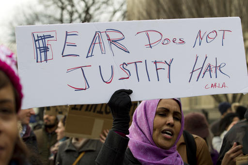 Demonstrators carrying signs chant as they protest outside of the White House during a demonstration to denounce President Donald Trumps executive order banning travel to the U.S. by citizens of Iraq, Syria, Iran, Sudan, Libya, Somalia or Yemen, Sunday, Jan. 29, 2017, in Washington.(AP Photo/Jose Luis Magana)