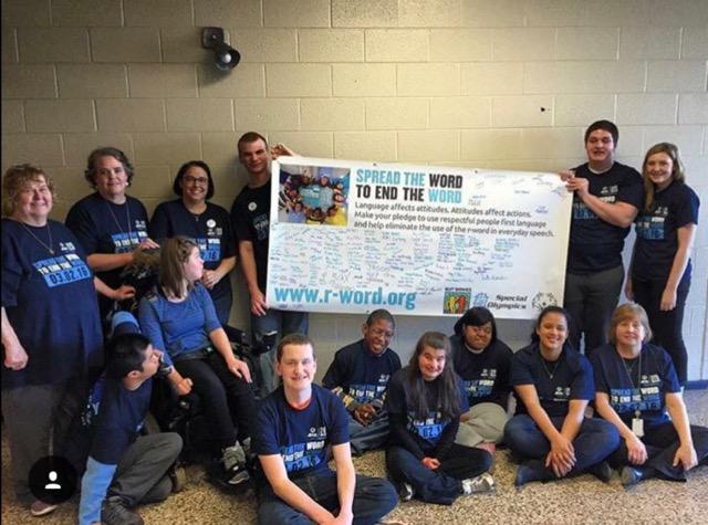 With the banner signed with pledges, students and staff from NPHS pose for a photo on the first annual Spread the Word to End the Word campaign at NPHS last year.