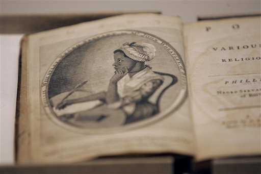 ** FILE ** A copy of a book by Phillis Wheatley, the first book written by an African American, is featured in an exhibit of black journalism as part Black History Month at the National Press Club in Washington in this Feb. 3, 2006, file photo. A first edition book by 18th-century writer Phillis Wheatley, who published her first poem when she was 13, was acquired by the University of South Carolina. There are roughly 100 first editions of Wheatleys Poems on Various Subjects, Religious and Moral, Patrick Scott, director of rare books and special collections at the universitys Thomas Cooper Library, said Thursday, Oct. 4, 2007. (AP Photo/Gerald Herbert, file)