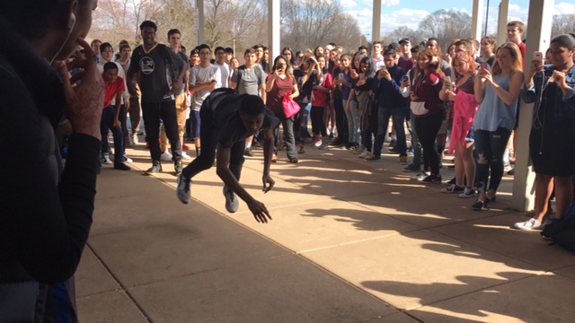 A student does a flip during lunch while enjoying music by DJ Noah Golden