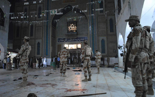 Pakistani para-military soldiers stand alert after a deadly suicide attack at the shrine of famous Sufi Lal Shahbaz Qalandar in Sehwan, Pakistan, Thursday, Feb. 16, 2017. An Islamic State suicide bomber targeted worshippers at a famous shrine in southern Pakistan on Thursday, killing dozens of worshippers and left hundreds of people wounded, officials said. (AP Photo/Pervez Masih)