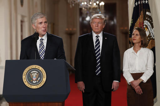 Judge Neil Gorsuch speaks as his wife Louise and President Donald Trump stand with him on stage in East Room of the White House in Washington, Tuesday, Jan. 31, 2017, after the president announced Judge Neil Gorsuch as his nominee for the Supreme Court. (AP Photo/Carolyn Kaster)