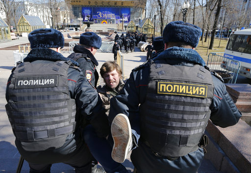 Police detain a protester in downtown Moscow, Russia, Sunday, March 26, 2017. Russias leading opposition figure Alexei Navalny and his supporters aim to hold anti-corruption demonstrations throughout Russia. But authorities are denying permission and police have warned they wont be responsible for "negative consequences" or unsanctioned gatherings. (AP Photo/Alexander Zemlianichenko)