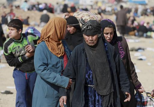 Iraqi civilians  who fled their homes because of fighting in Mosul, between Iraqi security forces and Islamic State militants wait to be transferred to camps for displaced people, on the western side of Mosul, Iraq, Wednesday, March 8, 2017. (AP Photo/Khalid Mohammed)
