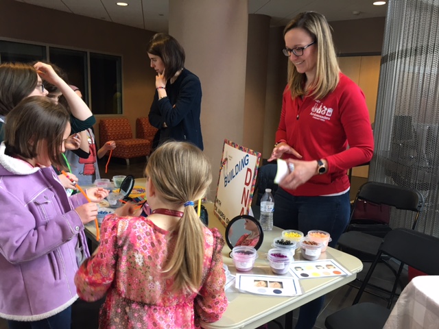 Girls work in a discovery lab during the Discover Your Future Event with Dr. Andrea Greyson, keystone speaker of the event, who is an industrial chemist.
