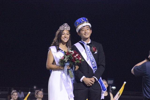 Olivia+Follis+and+Leo+Kawabata+stand+together+after+being+crowned+Homecoming+King+and+Queen+during+halftime+of+the+football+game.