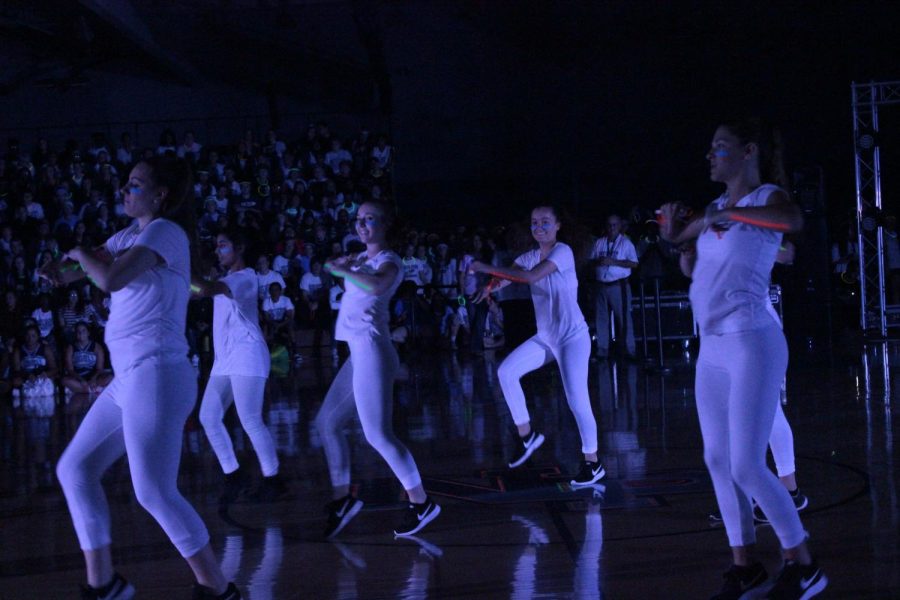 The North Penn dance team performs in all white outfits to glow in the blacklight 