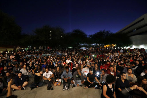 Students from University of Nevada Las Vegas hold a vigil Monday, Oct. 2, 2017, in Las Vegas. A gunman on the 32nd floor of the Mandalay Bay casino hotel rained automatic weapons fire down on the crowd of over 22,000 at an outdoor country music festival Sunday. (AP Photo/Gregory Bull)