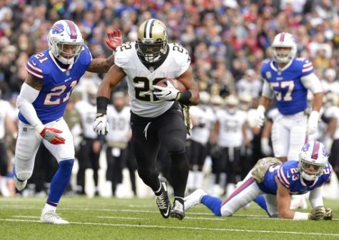 New Orleans Saints Mark Ingram (22) rushes past Buffalo Bills Jordan Poyer (21) and Micah Hyde (23) during the first half of an NFL football game Sunday, Nov. 12, 2017, in Orchard Park, N.Y. (AP Photo/Adrian Kraus)