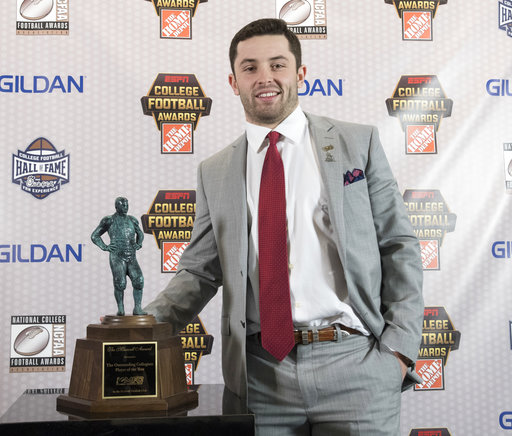 Oklahoma quarterback Baker Mayfield, winner of the Maxwell Award, poses with the trophy during the College Football Awards show at the College Football Hall of Fame, Thursday, Dec. 7, 2017, in Atlanta. (AP Photo/John Amis)