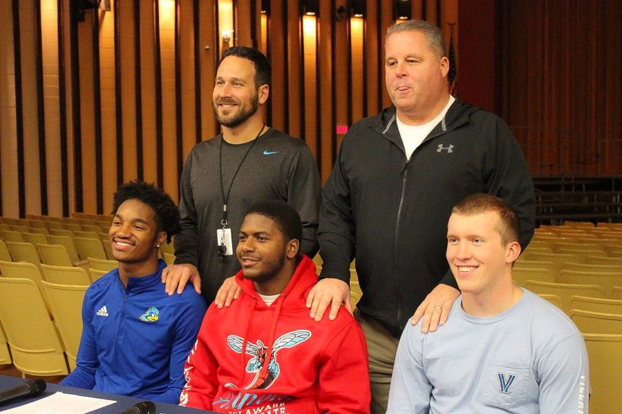 FOOTBALL- Justis Henley, Khan Jamal, and Owen Thomas are accomanied by coaches David Franek and Dick Beck to sign their National Letters of Intent.