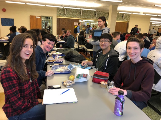 Ximena Trejo Mora, Christopher Owoc, Alex Vu, and Connor Ianetti pose for a picture at their lunch table.
