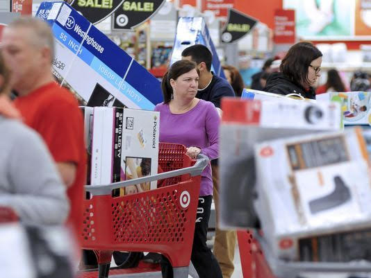 Shoppers maneuver through this Target store in Plainville, Mass., shortly after the store opened at 1 a.m. Friday, Nov. 25, 2016. Large screen televisions were among the popular items purchased. (AP Photo/Mark Stockwell)