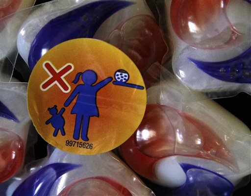 A warning label is attached to a package of Tide laundry detergent packets in Houston on Thursday, May 24, 2012. The miniature detergent packets arrived on store shelves in recent months, touted as a solution to bulky bottles and messy spills. But doctors across the country say children are confusing the tiny, brightly colored packets with candy and swallowing them. Nearly 250 cases have been reported to poison control centers. (AP Photo/Pat Sullivan)