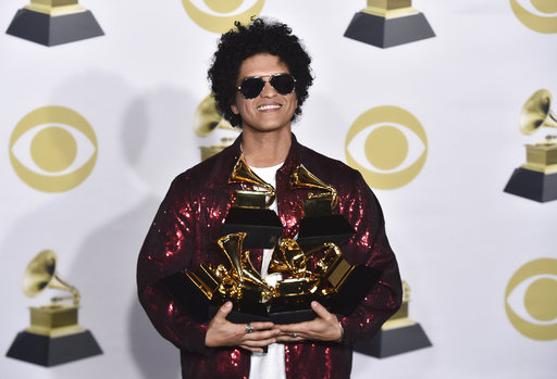 Bruno Mars poses in the press room with his awards for best R&B album, record of the year, album of the year, best engineered album, non-classical, for 24K Magic, and song of the year, best R&B performance and best R&B song, for Thats What I Like at the 60th annual Grammy Awards at Madison Square Garden on Sunday, Jan. 28, 2018, in New York. (Photo by Charles Sykes/Invision/AP)