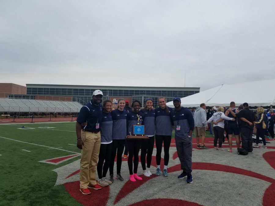 Mr. Brandon Turner, pictured on the right, with the girls track team at the state championship at Shippensburg. 