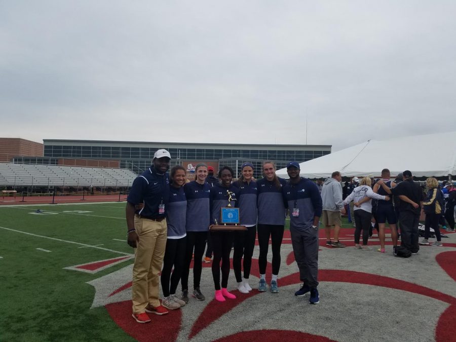 Mr.+Brandon+Turner%2C+pictured+on+the+right%2C+with+the+girls+track+team+at+the+state+championship+at+Shippensburg.+