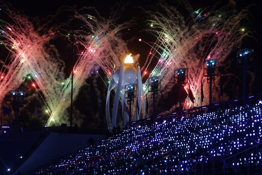 Fireworks explode over the Olympic flame during the closing ceremony of the 2018 Winter Olympics in Pyeongchang, South Korea, Sunday, Feb. 25, 2018. (AP Photo/Michael Probst)
