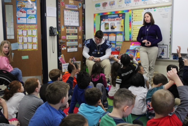 SUPER DAY: NPHS Football player Kyle Koestler reads to 1st grade students at North Wales Elementary School on Wednesday during the annual Reading Super Bowl.
