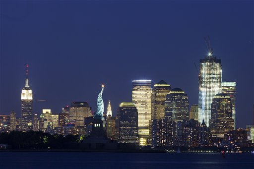 The Empire State Building, left, the Statue of Liberty, center, and One World Trade Center, right, are part of the New York skyline, Tuesday, Aug. 23, 2011. (AP Photo/Mark Lennihan)