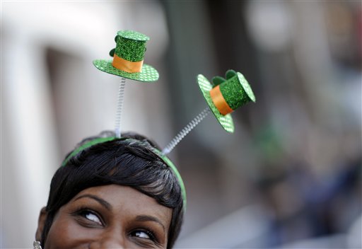 Krystal Thomas of Atlanta parties on River Street while wearing a shamrock headband during the 189th St. Patricks Day celebration, Friday, March 15, 2013, in Savannah, Ga. (AP Photo/Stephen Morton)