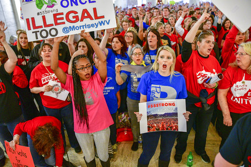 Teachers hold a rally outside the Senate Chambers in the West Virginia Capitol Monday, March. 5, 2018 in Charleston, W.V. Hundreds of teachers from 55 counties are on strike for pay raises and better health benefits,  (AP Photo/Tyler Evert)