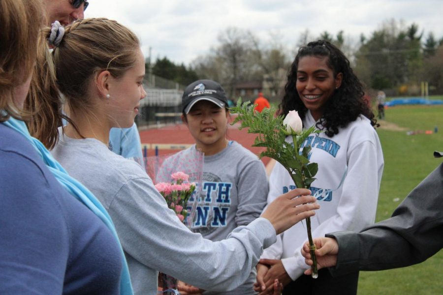 Senior+distance+runner+Olivia+Dyer+receives+flowers+for+senior+day+on+Tuesday%2C+April+24th.