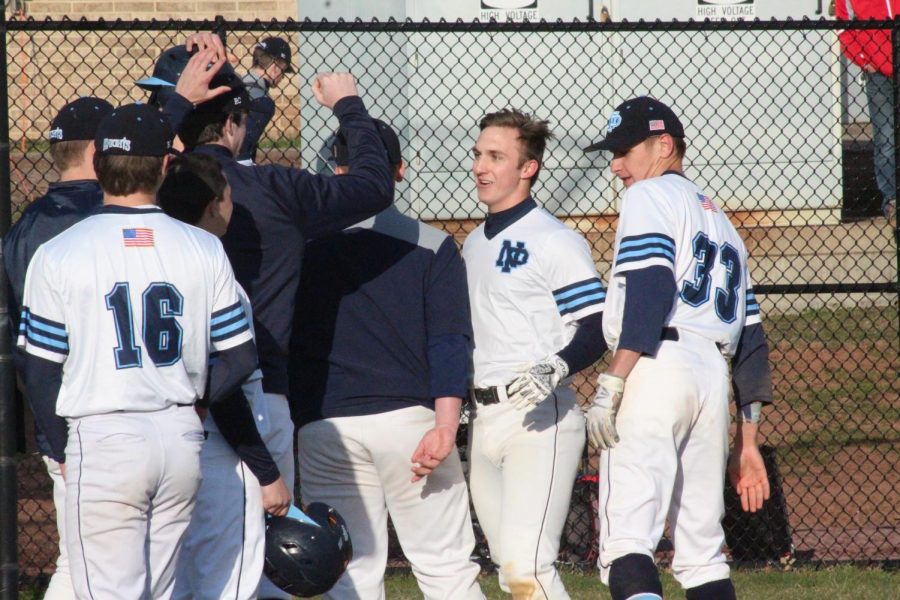 BASEBALL-+The+Knights+congratulate+Zach+Miles+on+his+home+run+as+he+gets+to+home+plate.