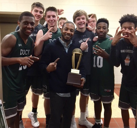 Mr. Etheridge (center) pictured with the basketball team he loves to coach. 
