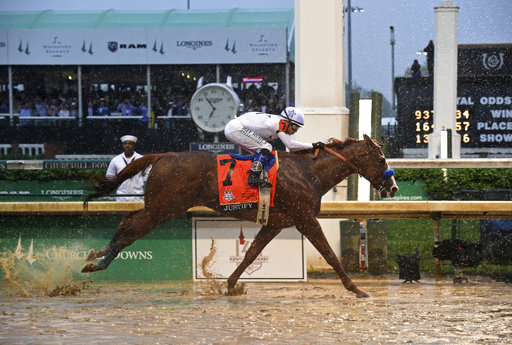 IMAGE DISTRIBUTED FOR LONGINES - Justify, ridden by jockey Mike Smith, wins the 144th Kentucky Derby, the wettest in history, on Saturday, May 5, 2018, at Churchill Downs in Louisville, Ky. Longines, the Swiss watch manufacturer known for its luxury timepieces, is the Official Watch and Timekeeper of the 144th annual Kentucky Derby. (Photo by Diane Bondareff/Invision for Longines/AP Images)