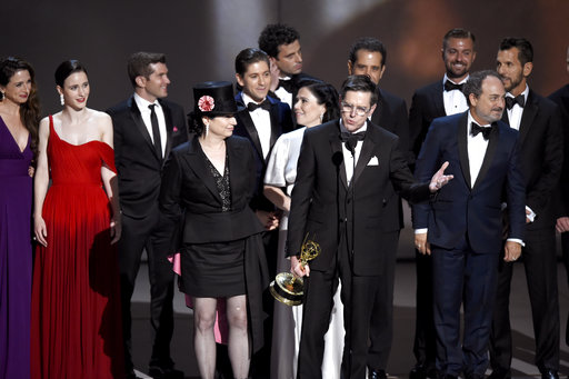Amy Sherman-Palladino, front and center left, Daniel Palladino and the cast and crew of The Marvelous Mrs. Maisel accept the award for outstanding comedy series at the 70th Primetime Emmy Awards on Monday, Sept. 17, 2018, at the Microsoft Theater in Los Angeles. (Photo by Chris Pizzello/Invision/AP)