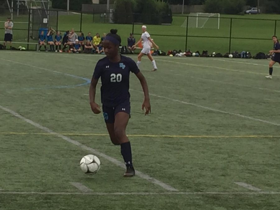Senior Zoei Baines dribbles  past midfield in a matchup against Souderton