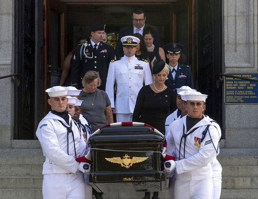 In this image provided by the U.S. Navy, Navy Body Bearers walk with the casket of Sen. John McCain, R-Ariz., followed by family members including Cindy McCain, to place it onto a horse-drawn caisson after his funeral service at the United States Naval Academy Chapel, Sunday, Sept. 2, 2018, in Annapolis, Md. McCain was buried in the cemetery at the Naval Academy. (Mass Communication Specialist 2nd Class Nathan Burke/U.S. Navy via AP)