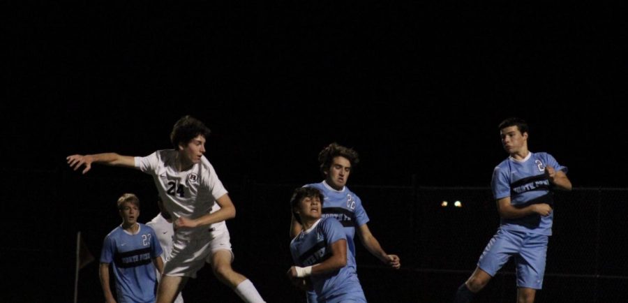 The North Penn boys soccer team jumping up to head the ball.