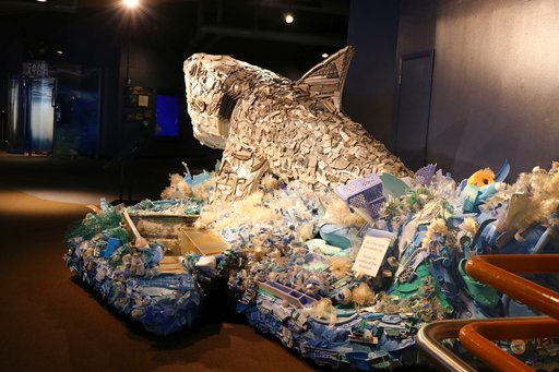 In this photo taken July 26, 2018, a section of a boat that washed ashore is incorporated into the sculpture of Greta the Great White Shark, one of six sculptures made out of ocean trash as part of a project called Washed Ashore: Art to Save the Sea at the Audubon Aquarium of the Americas in New Orleans. (AP Photo/Janet McConnaughey)