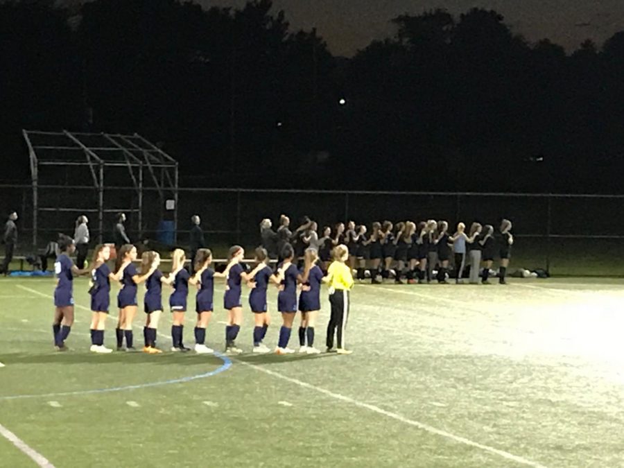 The Knights stand for the National Anthem right before the first whistle of their playoff game against the Avon Grove Red Devils