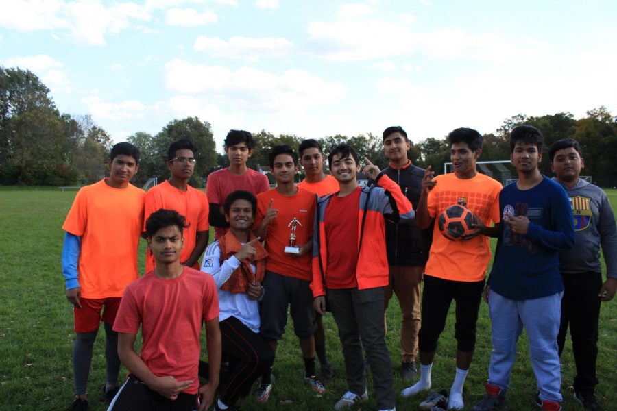 Bengali Club poses with their trophy after their win. 